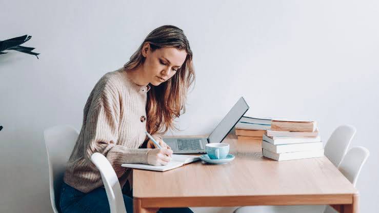 Photo of a blogger writing at home, Side Hustle Ideas for Introverts to Make Money Online from Home